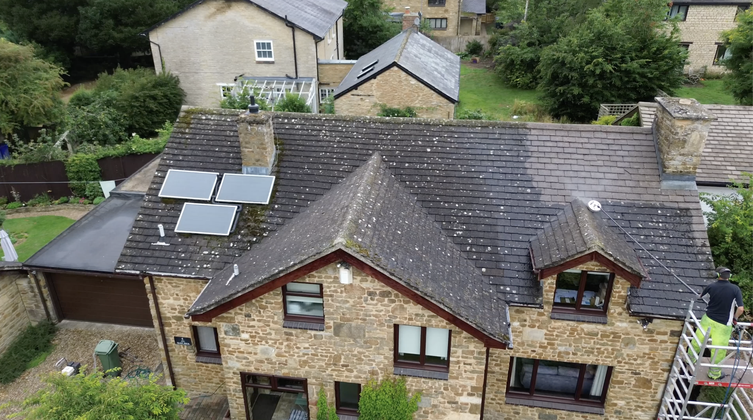 Professional roof cleaning equipment in use