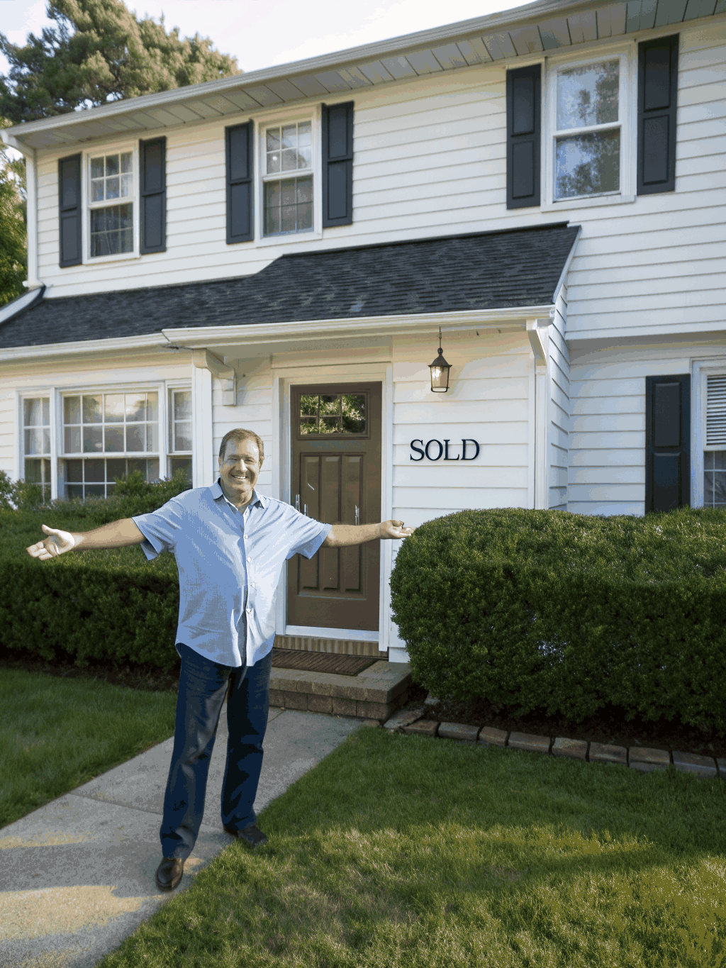 Homeowner admiring clean exterior render results
